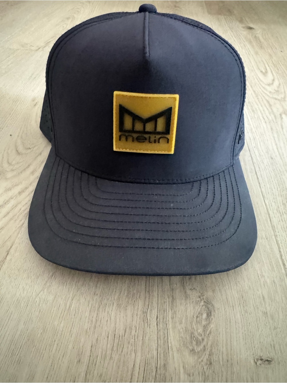 Melin Brand Black Hat with Yellow Logo Patch